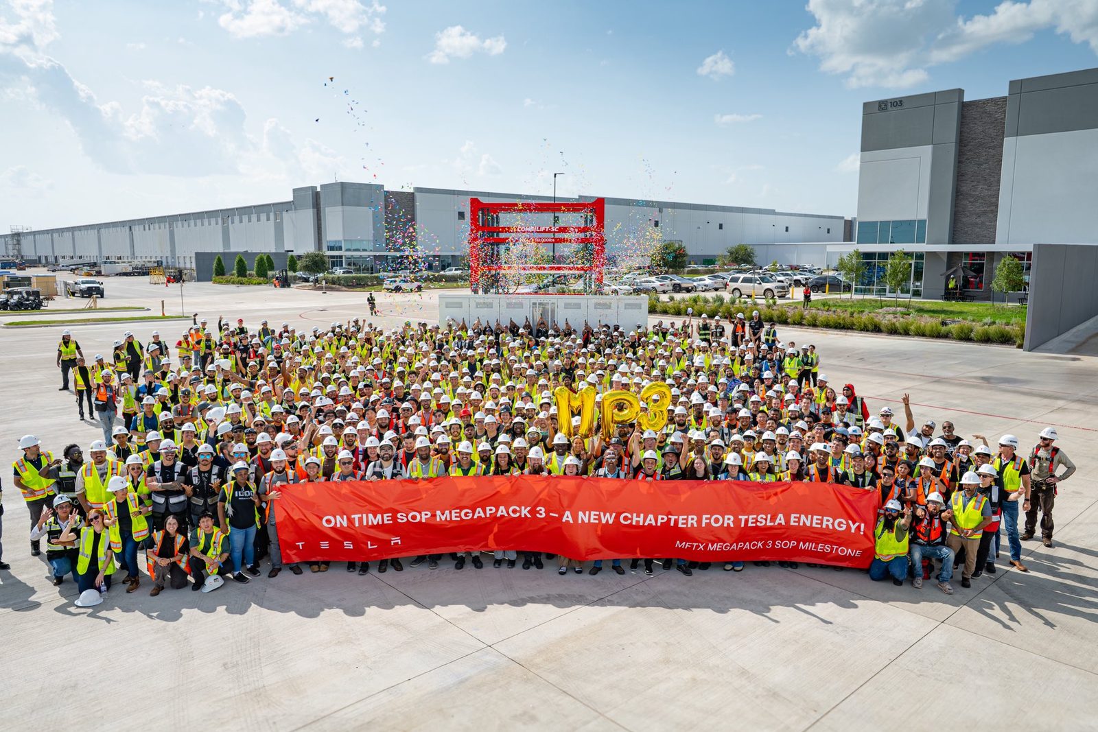 The Megafactory Texas team gathered outside the plant in Brookshire with a banner celebrating the on-time start of Megapack 3 production